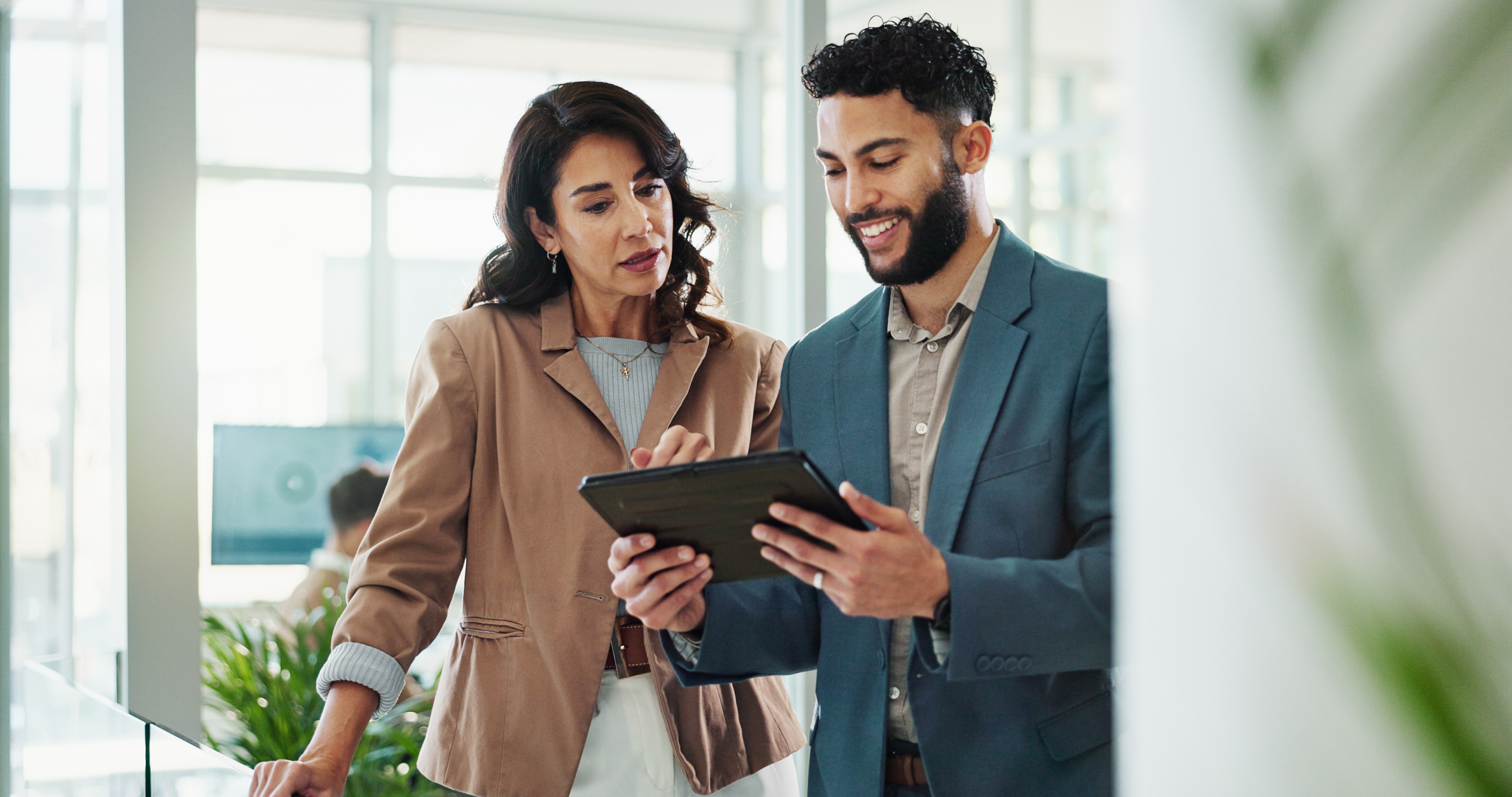 Young man sharing data with senior female leader